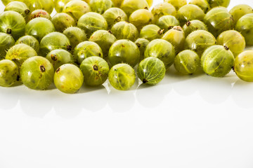 Gooseberries fruits on white background. Ripe summer fruits background with copy-space