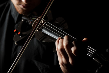 Close-up photo of man playing electric violin