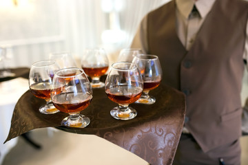 waiter with a tray welcomes visitors