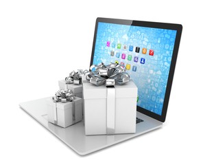 Gift box with ribbon bow on laptop keyboard