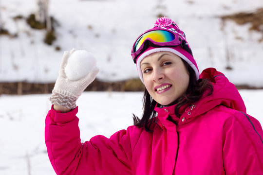 A young woman holds a snowball, Photography