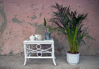 Vintage Coffee Set on White Decorative Table in Front of Pink Grunge Wall Texture