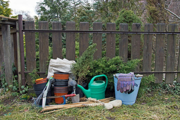 Gardening Tools with Watering Can,Flowerpots and Other Tools in Front of Garden Shed