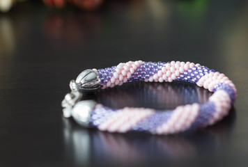 Handmade crochet beaded bracelet from beads of pink and lilac color