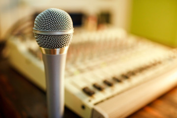 Microphone on sound mixer background. Copy space for  text.