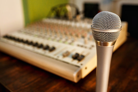 Microphone on sound mixer background. Copy space for  text.