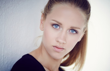 Portrait of blue eye's woman in a black dress.