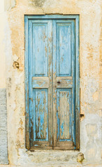 Weathered old blue mediterranean wooden door