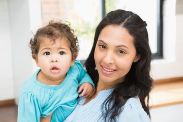 Smiling brunette holding her baby