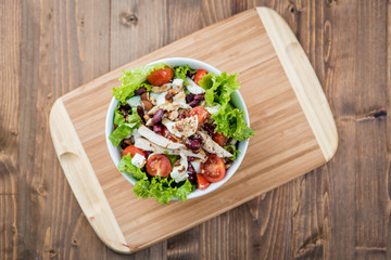 Fresh salad with salmon, quail eggs, cherry tomatoes and lettuce, closeup