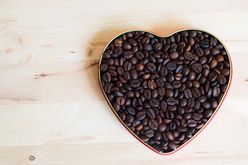Coffee beans in the heart on Valentine's Day, Wood background.
