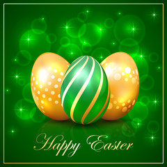 Three Easter eggs on green background