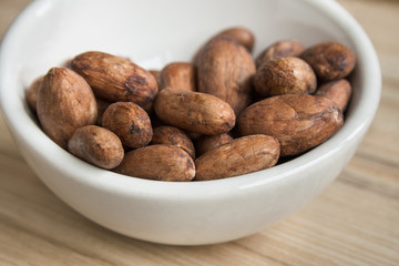 Close up image of cocoa beans in a bowl.