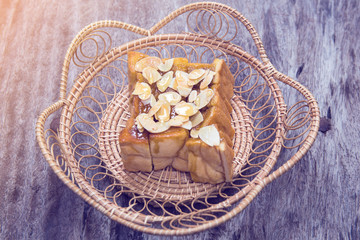 Fototapeta na wymiar toast or bread pour honey with pumpkin seeds on wood table