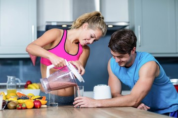 Healthy couple preparing a smoothie