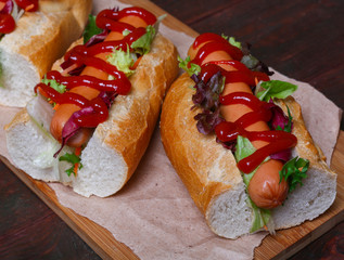home made Hot dog - sandwich with lettuce on wooden background