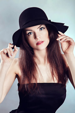 Woman in black dress and hat