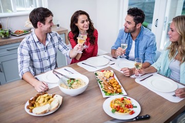 Smiling couple friends eating together