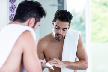 Handsome man shaving his beard