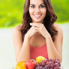 smiling woman with plate of fruits