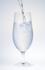 Water Pouring into Glass with Ice