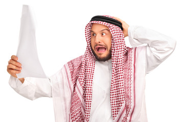 Shocked Arab looking at a piece of paper