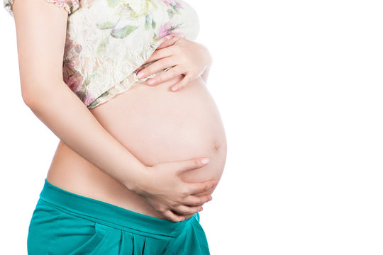 pregnant woman with her hands on his stomach on a white background