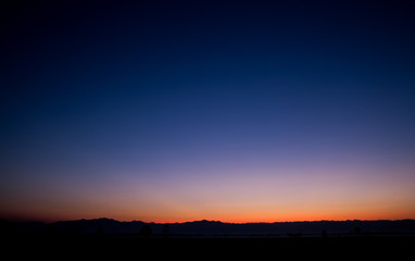 Fototapeta na wymiar Sunset and blue mountain