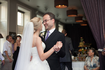 Romantic newlyweds, bride and groom first dance, holding hands,