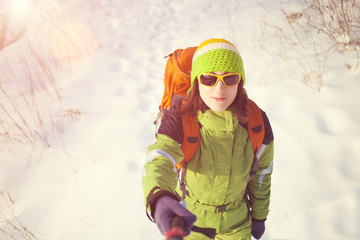 Girl in winter clothes makes a self-portrait.