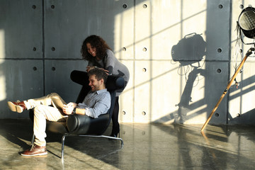 Fototapeta na wymiar Modern European couple with laptop relaxing at home