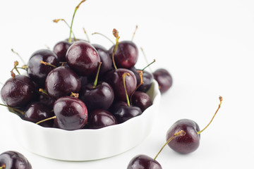Fresh dark purple cherry isolated white background