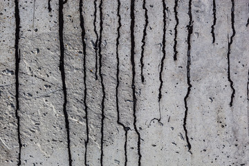 Obraz premium Grey concrete surface with black bitumen streaks