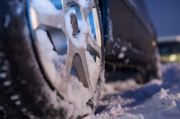Close up of car wheel in snow, selective focus, shalow depth of field