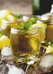 Glass of whiskey with mint and lemon