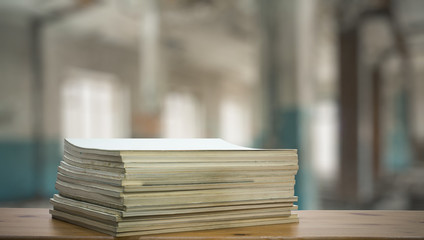stack of old magazines on wooden table