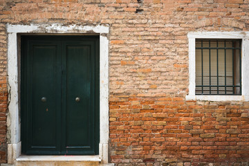 Old vintage door, window and wall in Venice, Italy.