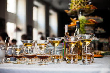 Luxury alcohol wedding table arrangement: cognac, wine and scotc