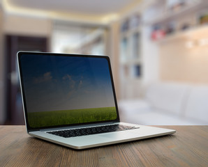 computer on wooden table in room