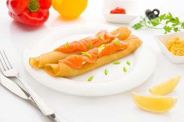 Breakfast with pancakes and salmon on the white background