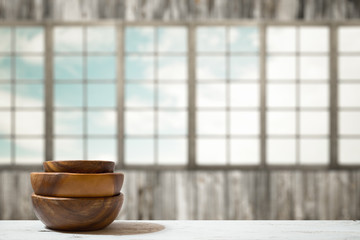 stack of empty wooden bowls on table