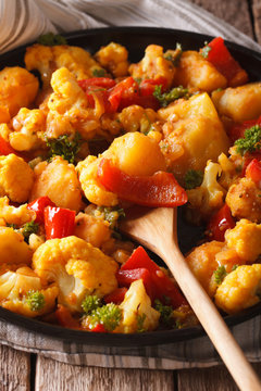 Indian cuisine: Gobi Aloo close-up on a plate. Vertical