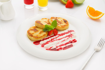Delicious homemade cheese pancakes with cream and jam