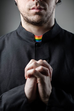 Catholic Gay Priest Praying with Rainbow Collar
