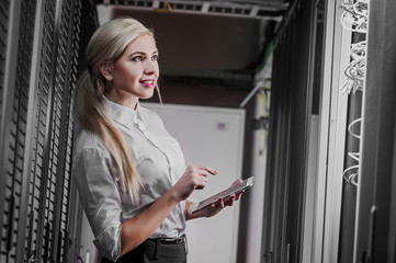 Young engineer businesswoman in server room