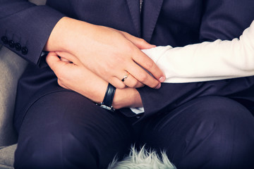 groom holds the bride's hand