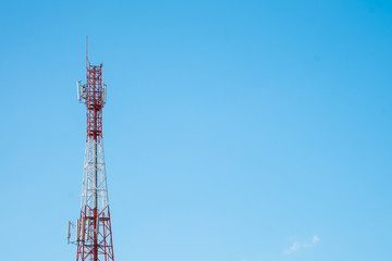 Telecommunication tower with antennas with blue sky background
