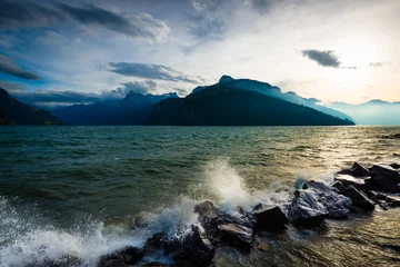 Tuinposter Storm and wind on the lake of  Swiss Alps. Splash of waves in the setting sun. © patma145