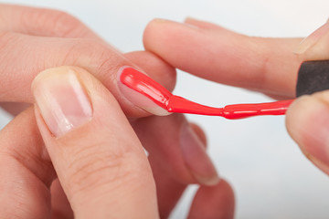 Manicure specialist painting clients nails