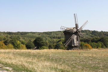 Fototapeta na wymiar Old wooden mill in the field